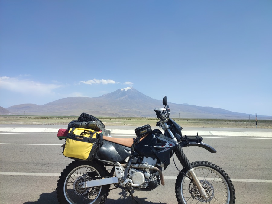 Suzuki DR-Z400S with luggage beside a mountain road